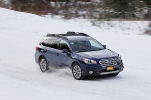 Subaru displaying safe driving on snow covered roads.
