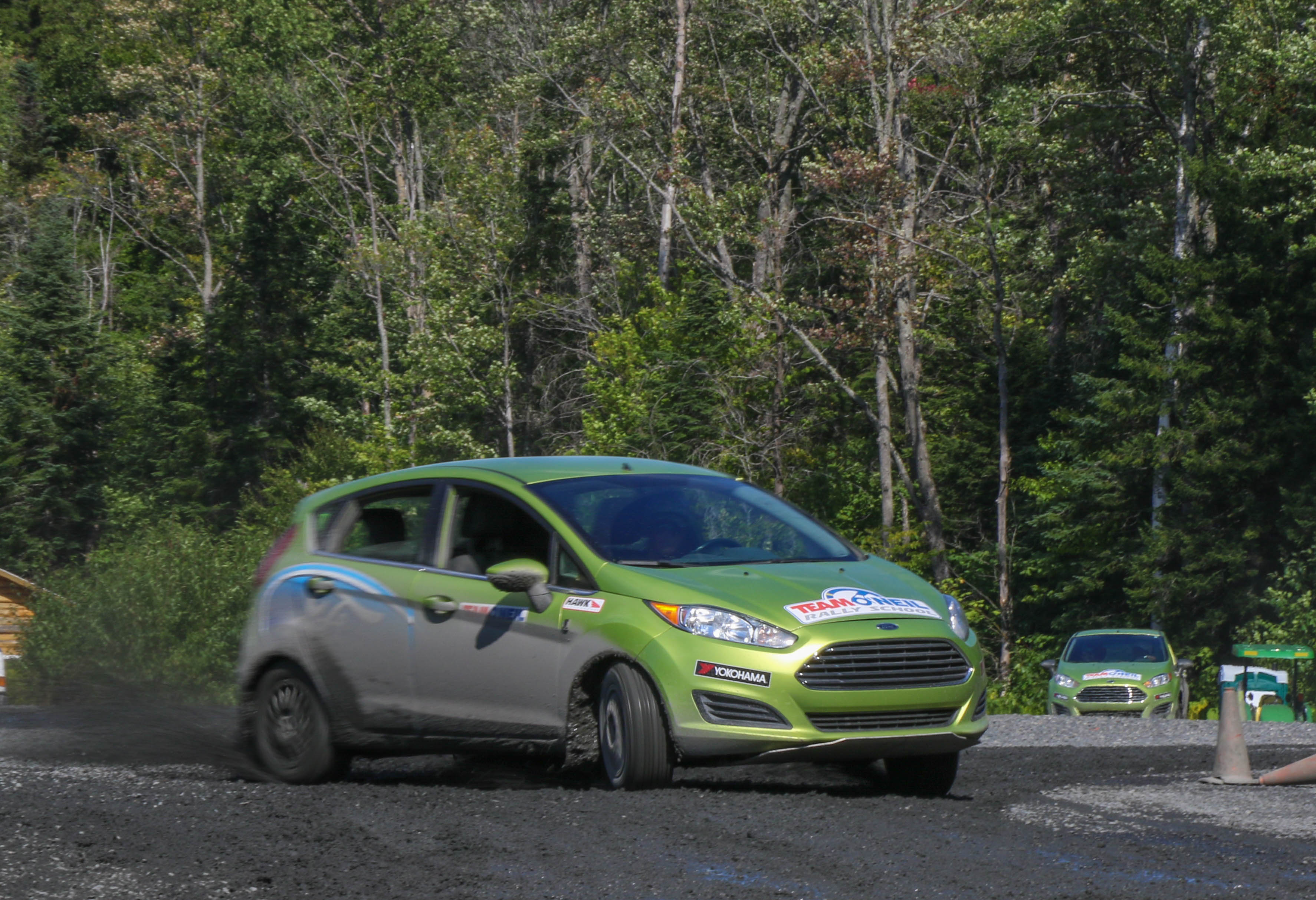 Ford Fiesta executing advanced rally driving on a gravel surface at Team O'Neil in New England