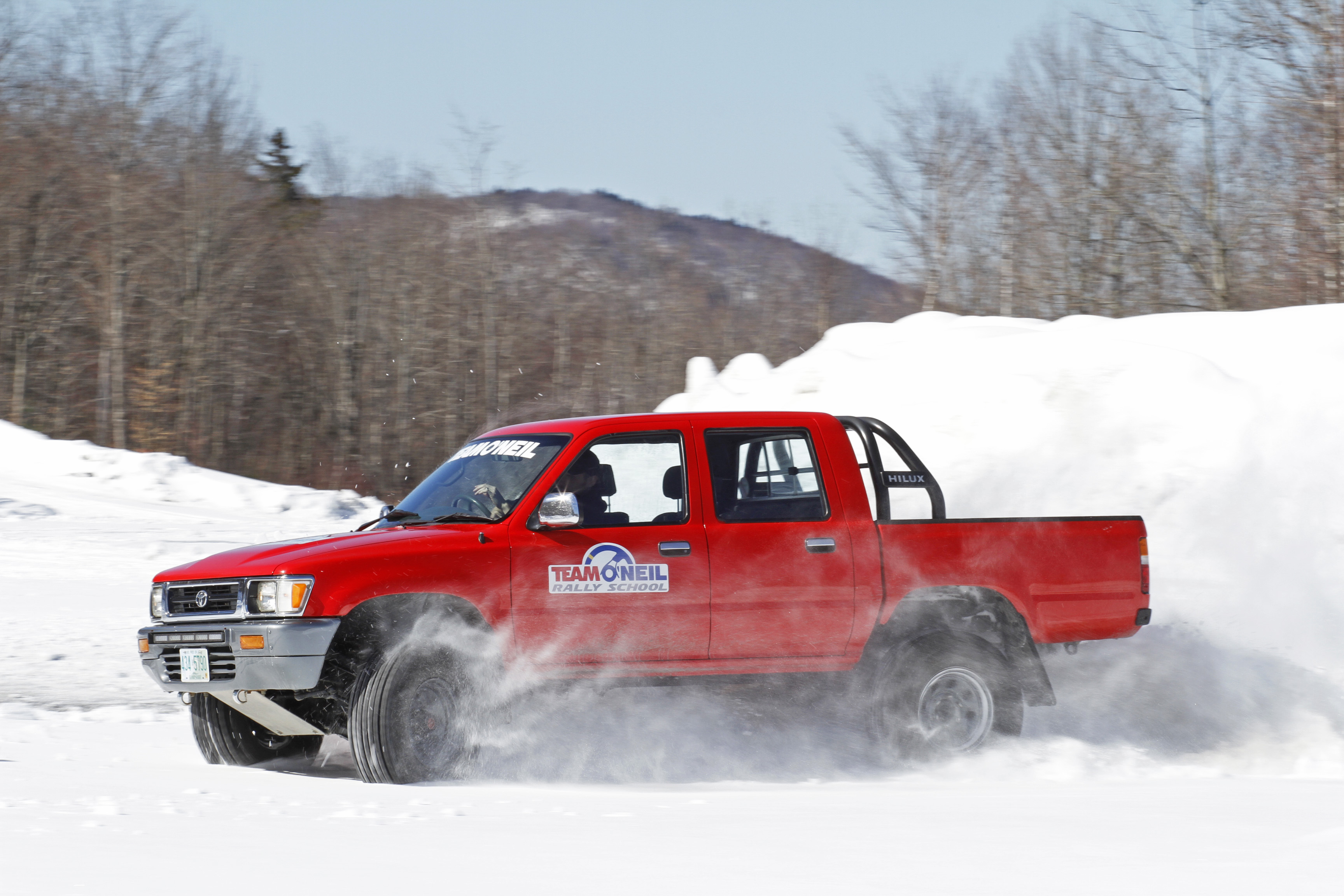 Toyota HiLux driving through snow in the White Mountains in New Hampshire