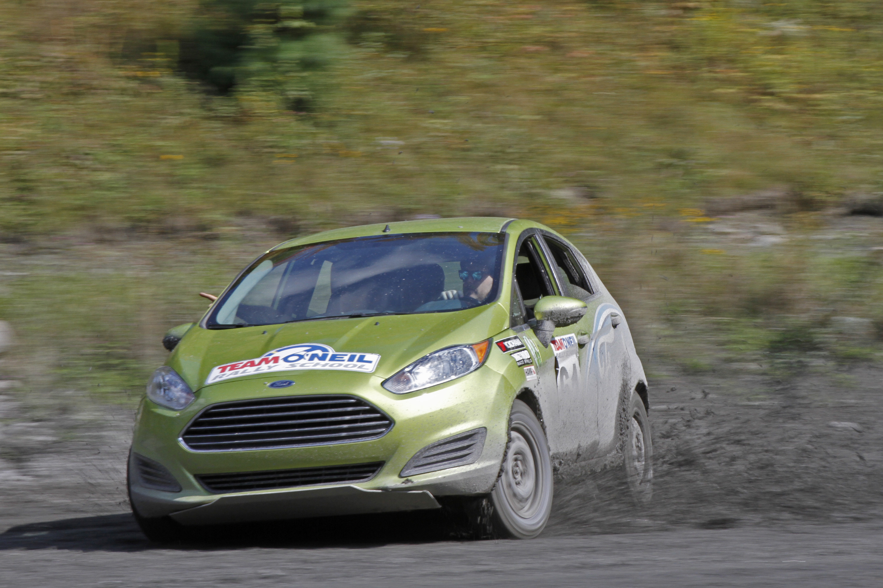 A Ford Fiesta displaying the use of weight transfer on a rally road.